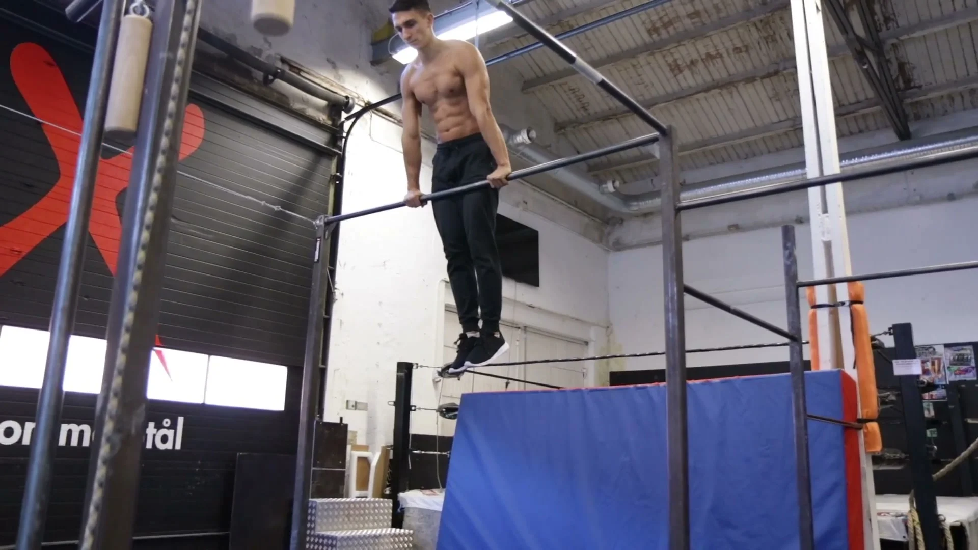 Dynamic muscle up on a higher bar showing the jump-to-bar entry and full movement execution for more advanced training