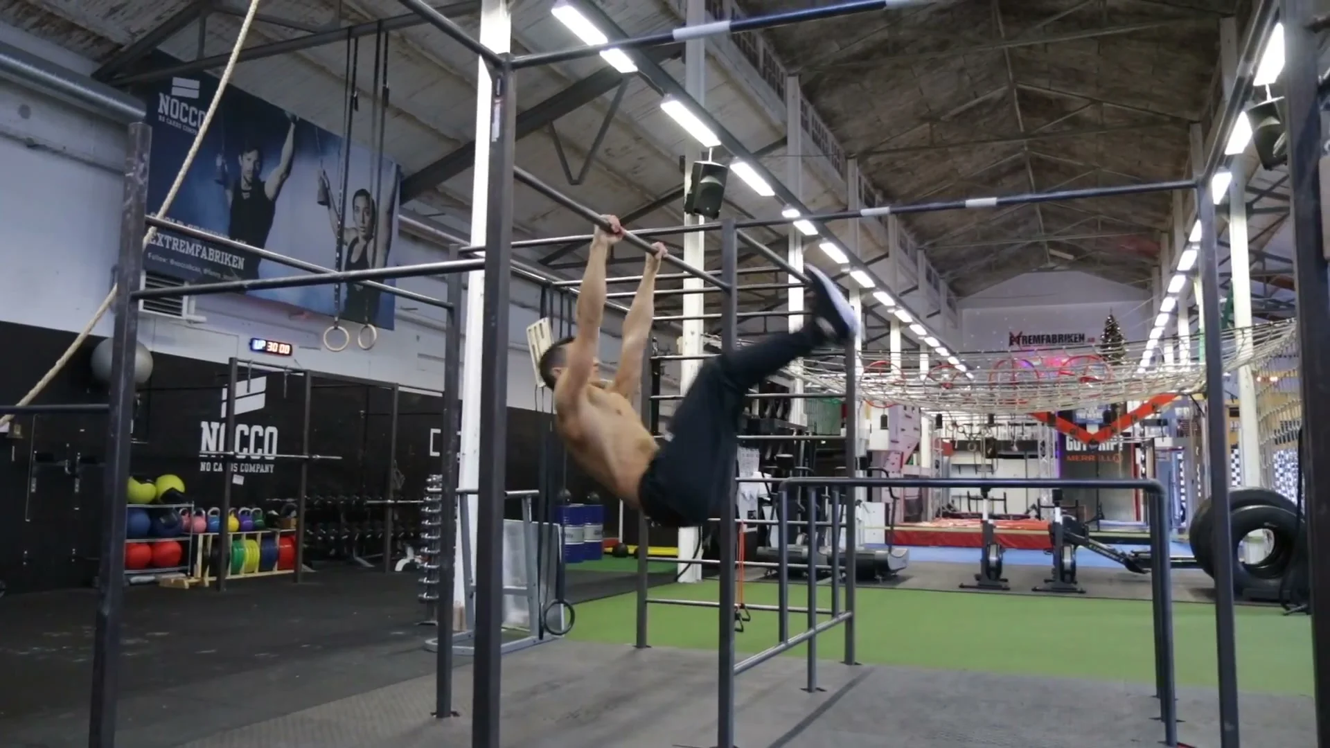 Kick-down phase of the dynamic muscle up just before bar contact, upper body beginning to travel over the bar
