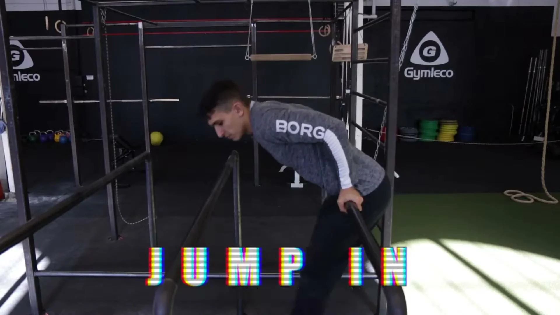 Jump in parallel bar trick showing Daniel between the bars about to demonstrate the second trick