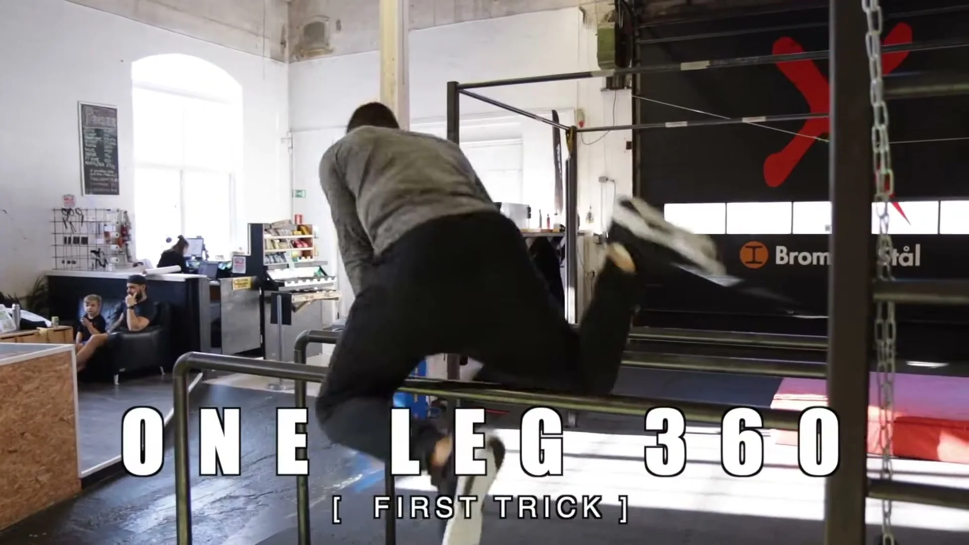 Daniel Flefil performing the one leg 360 on parallel bars, title card showing ONE LEG 360 FIRST TRICK