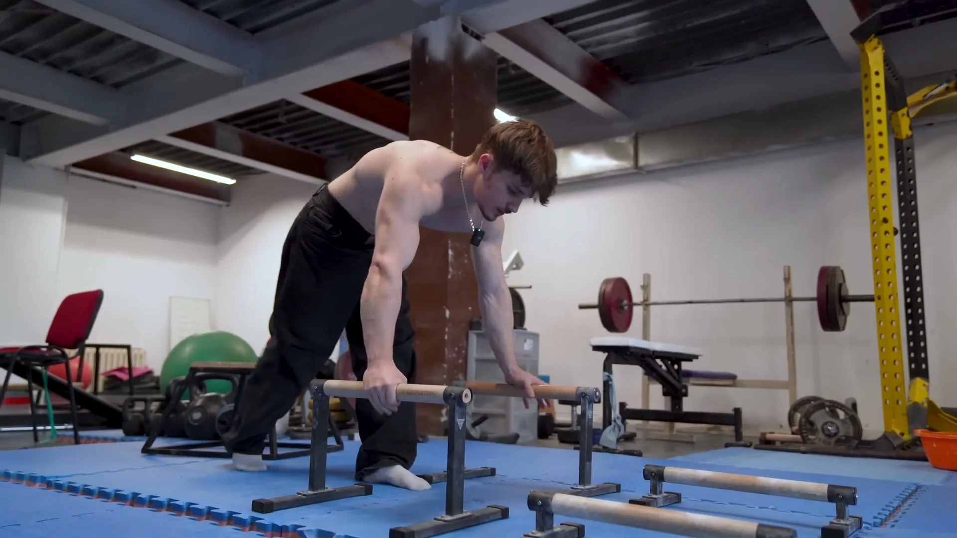 Nathan Bosech performing a planche to handstand transition on high calisthenics bars
