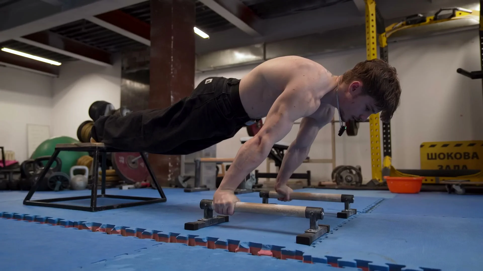 Nathan demonstrating elevated feet planche push-up on a step with body in planche line