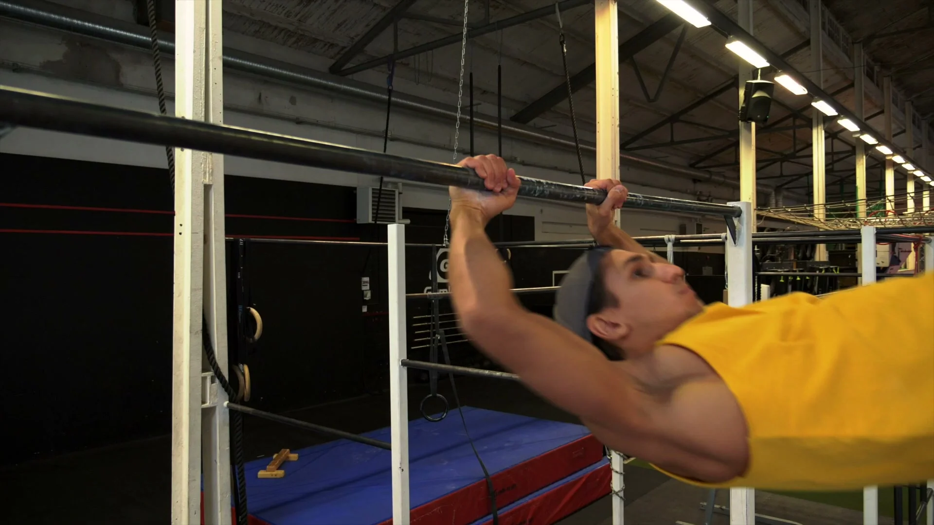 V-sit muscle up timing cue: body position at the exact moment when feet pass the bar and the pull upward should begin