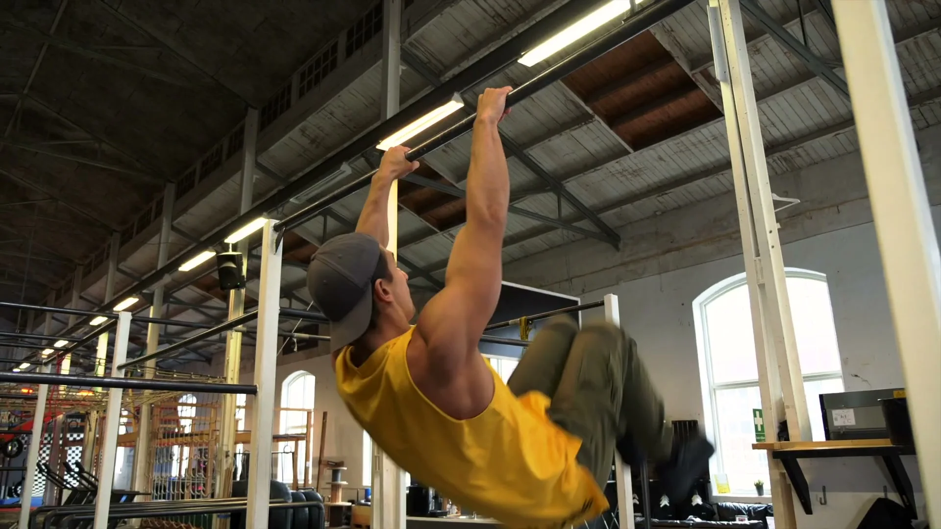 Tuck version of the V-sit muscle up: legs tucked in at the back of the swing, body learning the coordination pattern without flexibility demand