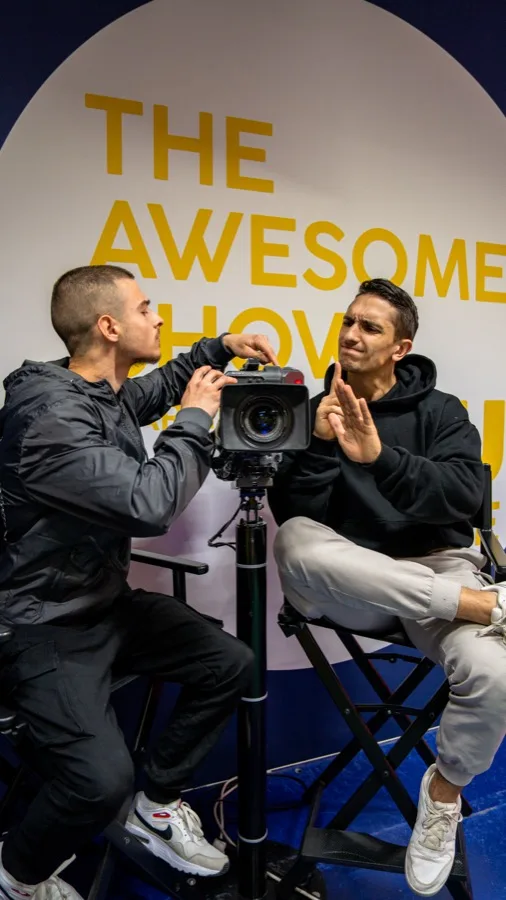 Daniel Flefil operating a professional Sony camera at a filming event, behind the scenes of content production